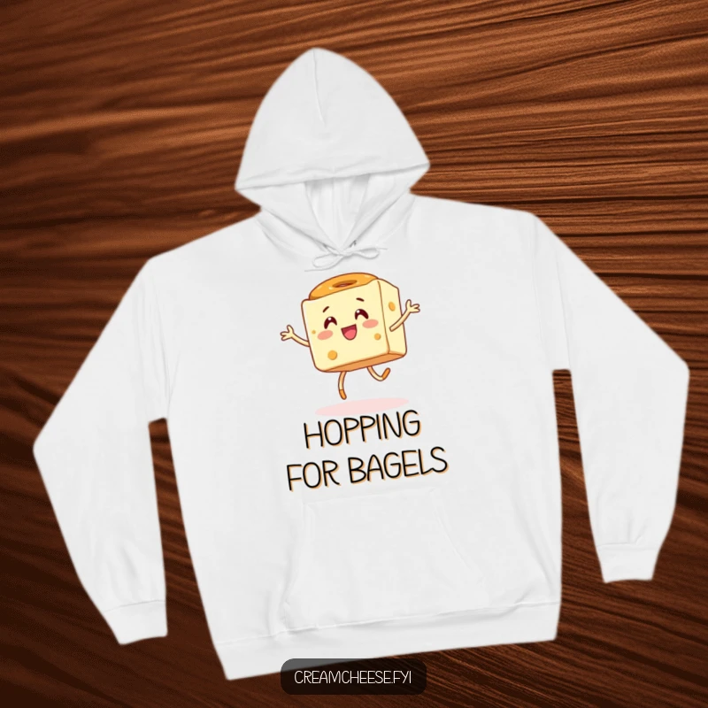 Funny hoodie depicting an energetic cream cheese cube in a silly hop with a bagel, radiating pure, joyful breakfast energy.