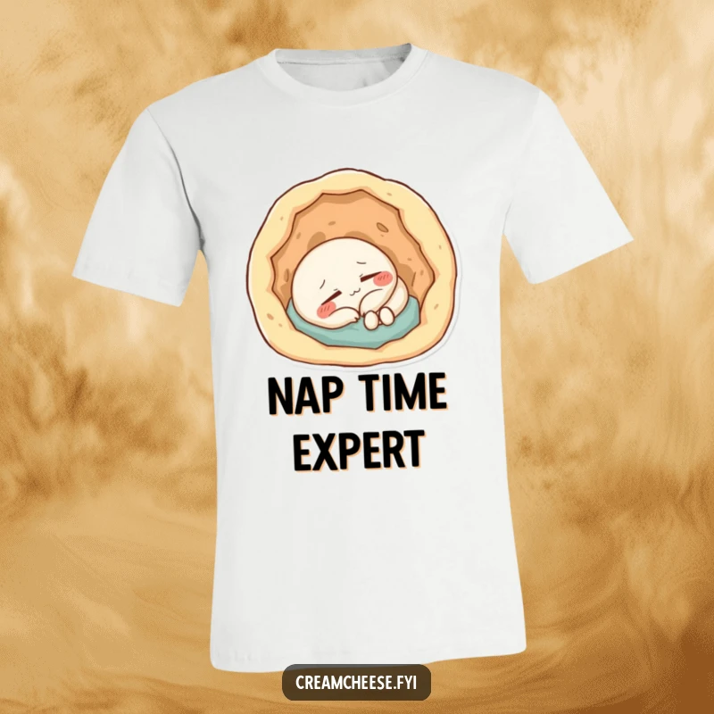 Funny T-Shirt: Content cream cheese character napping soundly within a small, inviting, doughy indentation.